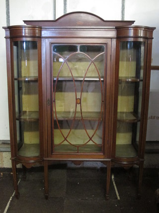 An Edwardian inlaid mahogany display cabinet with raised back,  the shelved interior enclosed by glazed panelled doors, raised on  square tapering supports ending in spade feet 48"