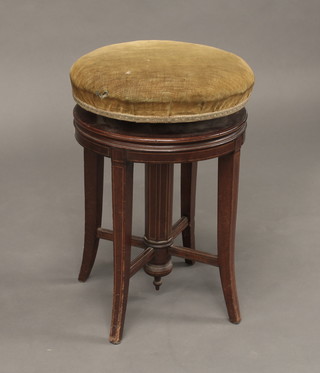 A Victorian inlaid mahogany adjustable revolving piano stool raised on 4 chamfered supports with X framed stretcher
