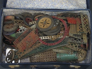A blue suitcase containing a collection of Meccano