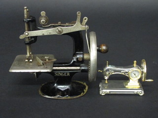 A childs Singer no.20 manual sewing machine together with a miniature model of a sewing machine containing a clock