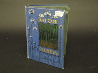 A blue album containing approx 153 various postcards