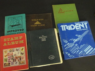 A Stanley Gibbons Trident stamp album, a Cavalier stamp album and 3 other stamp albums