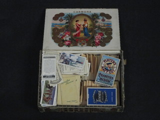 A cigar box containing cigarette cards