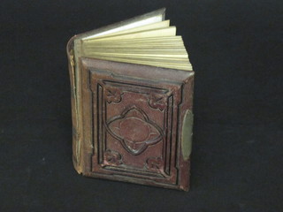 A Victorian leather bound photograph album containing various black and white photographs