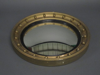 A circular convex plate wall mirror contained in a ball studded  frame 28"