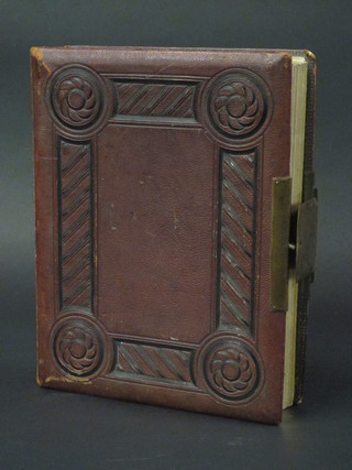 A Victorian red leather bound photograph album, empty,