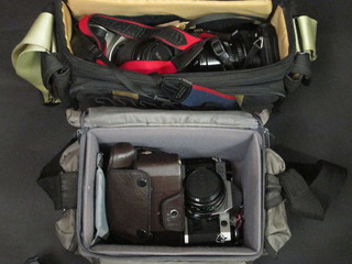 2 Canon AE1 programme cameras, a Canon EOS300 camera and  a Miranda M camera contained in a 2 fabric carrying cases
