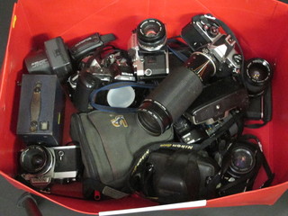 A Nikon FN2 camera, a Nikon F65 camera, an Olympus OM, a  Nikon F401S and 10 other cameras