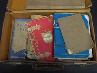 A leather attache case containing various dancing pamphlets and books