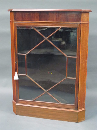 An Edwardian inlaid mahogany corner cabinet, the interior fitted shelves enclosed by astragal glazed panelled doors, raised on a  platform base, 32"