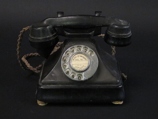 A black Bakelite dial telephone