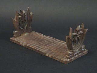 A pair of carved hardwood expanding bookends