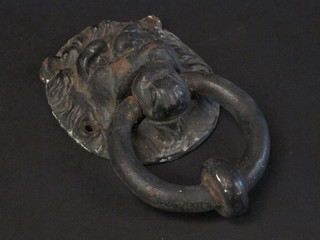 A metal lion mask door knocker