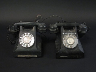A black Bakelite dial telephone the base marked E2312L and 1 other