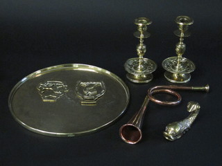 A pair of brass candlesticks, a brass figure of a dolphin, 2 horse  brasses, a brass tray and a copper hunting horn