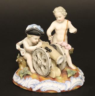 A Dresden porcelain figure group of 2 cherubs firing a canon, raised on an oval base, the base marked R, 6"