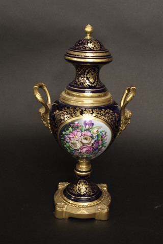 A blue Sevres style porcelain twin handled urn with gilt metal mounts 16 1/2"