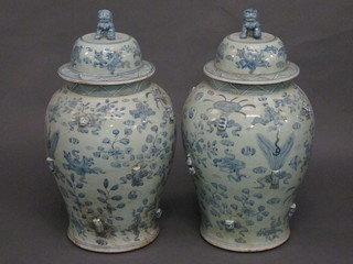 A large pair of Oriental blue and white porcelain urns and covers  25"  ILLUSTRATED