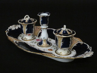 A 19th Century Derby style porcelain boat shaped inkstand, the centre with candlestick flanked by a pair of lidded urns, raised on  a boat shaped base 13"