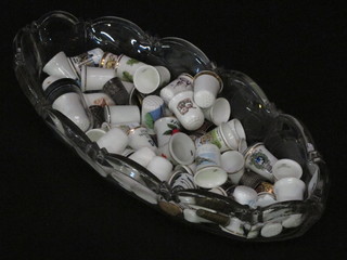 A glass bowl and a collection of thimbles