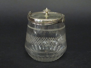 A circular etched glass biscuit barrel with silver plated mounts