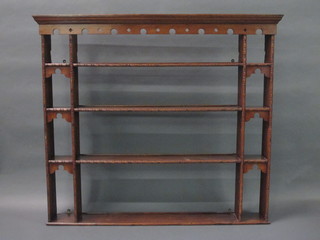 A honey oak plate rack with moulded cornice fitted 4 shelves  57"