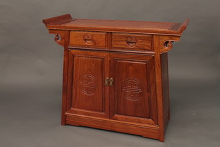 An Oriental hardwood altar style cabinet fitted 2 long drawers above a double cupboard enclosed by panelled doors 37"