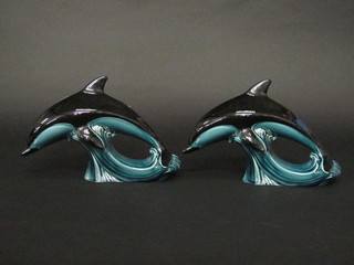 A pair of Poole Pottery blue glazed figures of diving dolphins  11"