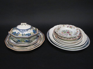 A 7 piece Royal Doulton Merryweather pattern dinner service  with pair of twin handled oval tureens 9" - 1 cracked, 3  graduated meat plates 16" and 13" - cracked and 11", 2 circular  plates 9 1/2" - cracked and a collection of meat plates and other  decorative plates