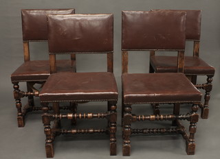 A set of 4 oak framed Cromwellian style dining chairs with  upholstered seats and backs, raised on turned and block supports