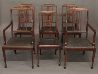 A set of 6 Edwardian inlaid mahogany stick and rail back dining chairs - 2 carvers, 4 standard, raised on square tapering supports  ending in spade feet