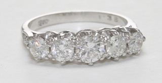 An 18ct white gold dress ring set 5 circular cut diamonds and  with diamonds to the shoulders, approx 1.35ct