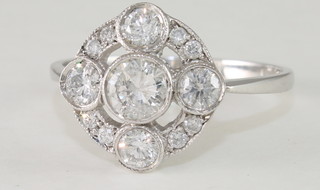 A lady's 18ct white gold cluster dress ring set 4 diamonds  supported by diamonds, approx 1ct