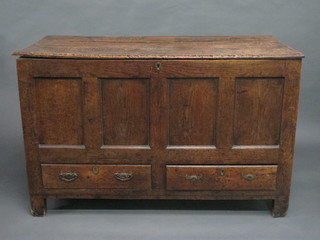 A 17th/18th Century oak coffer of panelled construction with hinged lid, the base fitted 2 drawers 49"