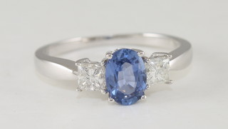 A lady's 18ct white gold dress ring set an oval cut sapphire and  with 2 circular sapphires to the shoulders