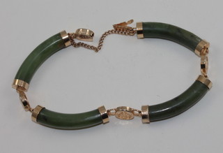 A green hardstone bracelet with gilt mounts