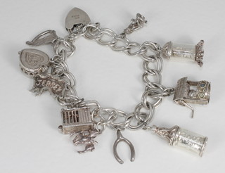 A silver charm bracelet hung 10 various charms