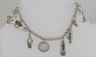 A silver curb link charm bracelet hung 8 various charms