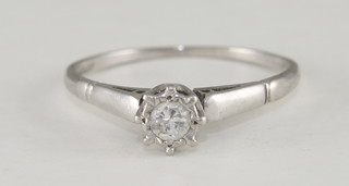 A white gold or platinum dress ring set a solitaire diamond