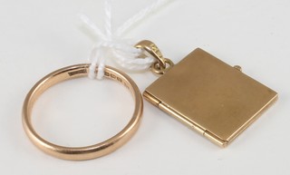 A 9ct gold wedding band and a gilt metal locket