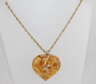 A 14ct gold multi link chain hung an amber heart shaped pendant