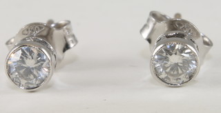 A pair of circular diamond ear studs approx 0.43ct