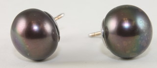 A pair of black pearl and diamond ear studs