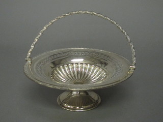 A circular pierced silver plated cake basket with handle