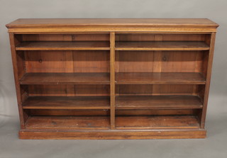 A Victorian walnut bookcase the interior fitted adjustable shelves,  raised on a platform base 73"