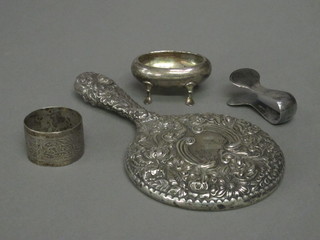 A silver backed hand mirror, an oval silver salt, a silver napkin ring and a pair of white metal tongs