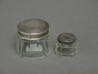 A circular glass jar with silver lid 1" and 1 other