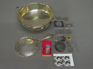 A silver backed hand mirror, a small collection of coins, stamps  and a silver plated twin handled bowl