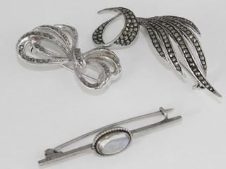2 marcasite brooches and a brooch set a cabouchon cut  moonstone