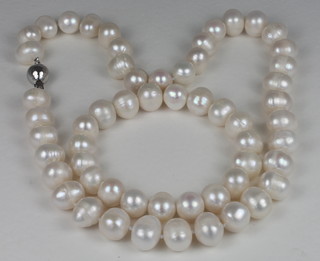 A pearl necklace and matching bracelet with silver clasps